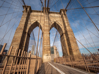 Close Up Picture of the one of the Brooklyn Bridge Towers With Blue Skies in the Background