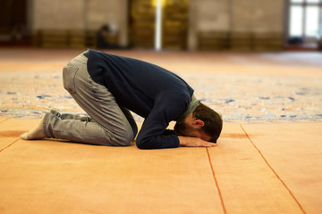 Muslim man praying in a mosque