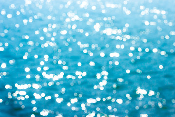 Abstract bokeh sunlight background with summer blue sea.