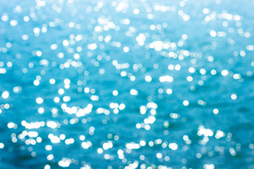 Naklejka premium Abstract bokeh sunlight background with summer blue sea.