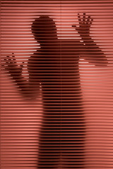 Man shadow behind the window