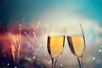 Glasses of champagne against holiday lights