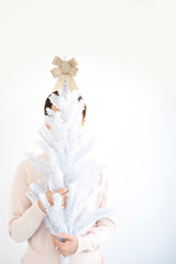 woman holding white christmas tree