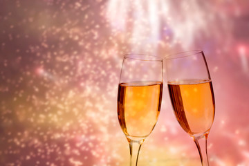 Glasses of champagne against holiday lights