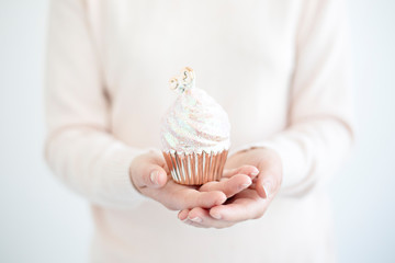 woman holding cupcake