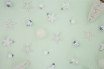 white ornaments in green background