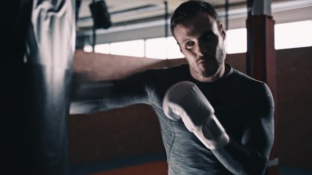 fit boxer training martial arts on a punching bax