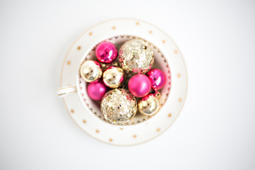 pink and gold christmas balls  in a bowl