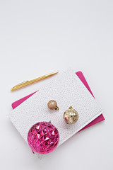 gold and pink christmas ornament in white background