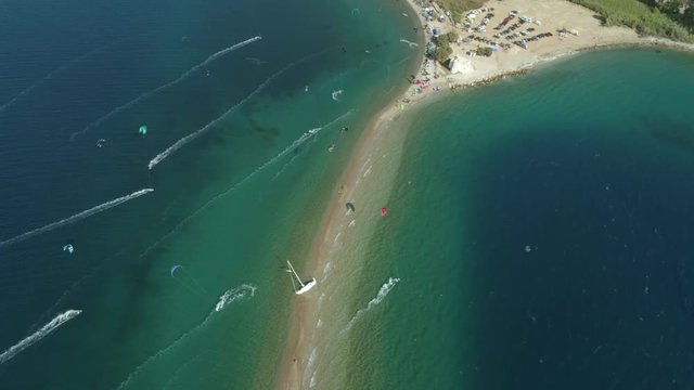 Aerial view faraway of group kitesurfing at Gulf of Patras, Greece.