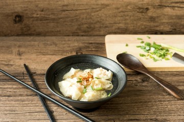 Shrimp wonton with braised pork in soup on wooden table - Asian food style  / Select focus image