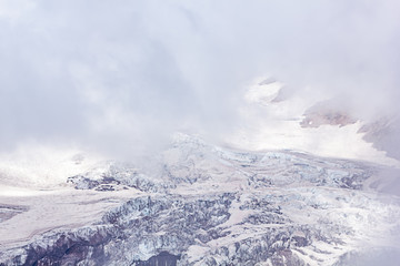 Fototapeta na wymiar white cold snow fields in mist on mountain side