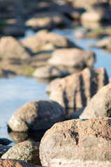 Blue pebble isolated at dusk in a rocky creek