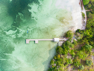 Aerial top down view tropical beach pier caribbean sea at Pasir Panjang. Indonesia Moluccas archipelago, Kei Islands, Banda Sea. Top travel destination, best diving snorkeling, stunning panorama.