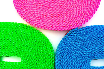top view blue red and green plastic clotheslines close up on white