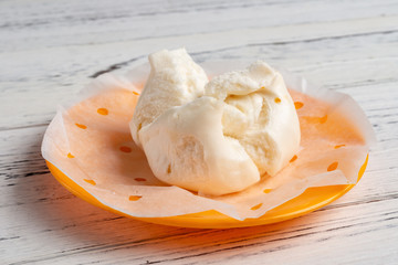 side view traditional Chinese bun on white wood background
