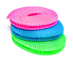 blue red and green plastic clotheslines stacked up on white