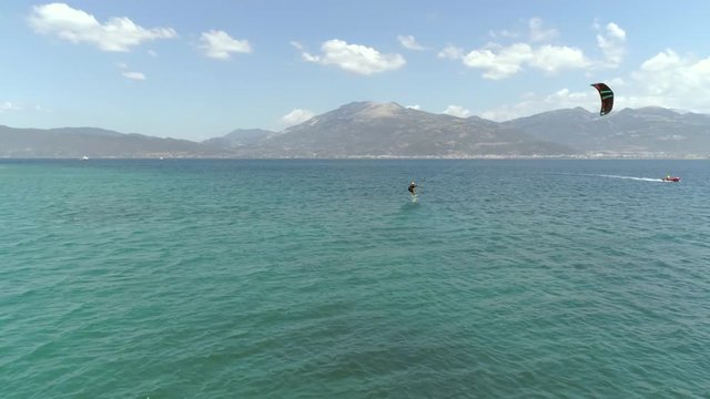 Aerial view of person kitesurfing in the Gulf of Patras, Greece.