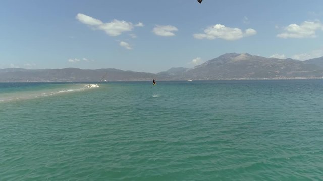 Aerial view of person jumping windsurfing at the Gulf of Patras, Greece.