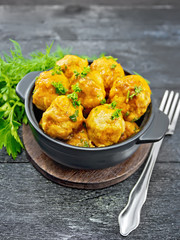 Meatballs in black brazier on board