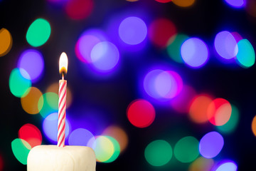 Birthday candle with bokeh lights