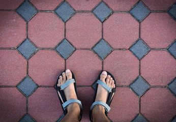 foot on cement brick block walk path from above (selective focus)
