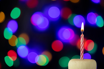 Birthday candle with bokeh lights