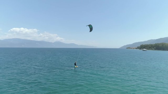 Aerial view of person kitesurfing in the Gulf of Patras, Greece.