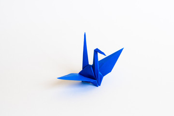 blue Origami crane on white background