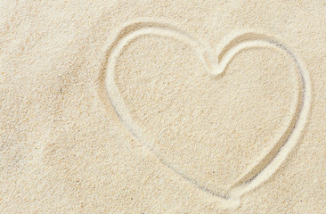 Fototapeta na wymiar Heart shape on the sand beach