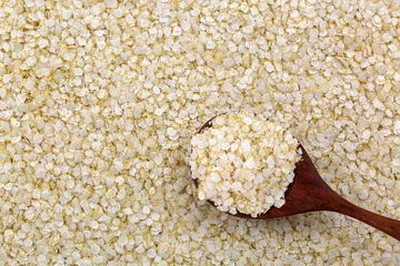 Keuken spatwand met foto Rolled white Quinoa seed gluten-free flakes. Flattened organic grains high in protein, dietary fiber, B vitamins, dietary minerals © sasimoto