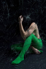 Woman behind a broken window