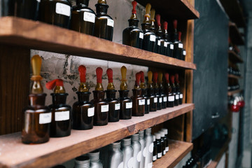 Chemical worker, Chemistry, Experiment, Vials. Close up amber color bottles on the shelf in old perfume laboratory. Flasks and examples of odor in the perfume shop.