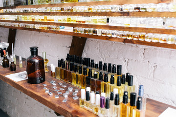 Close up color bottles on the shelf in old perfume laboratory. Flasks and examples of odor in the...