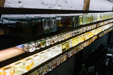 Close up color bottles on the shelf in old perfume laboratory. Flasks and examples of odor in the perfume laboratory and shop