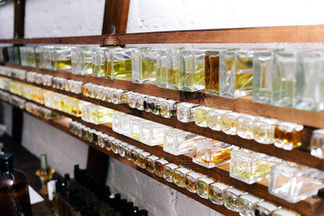 Close up color bottles on the shelf in old perfume laboratory. Flasks and examples of odor in the perfume laboratory and shop