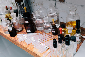 Chemical worker, Chemistry, Experiment, Vials. Close up amber color bottles on the shelf in old perfume laboratory. Flasks and examples of odor in the perfume shop.