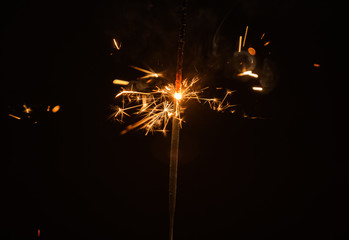 Sparkler burning down in the dark. Selective focus.