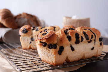 Homemade bread with eggs and bag of flour on gray background