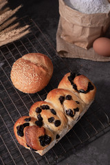 Homemade bread with eggs and bag of flour on gray background