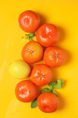 Tangerines on yellow background