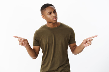 Studio shot of troubled serious-looking confused handsome african american male model looking right...