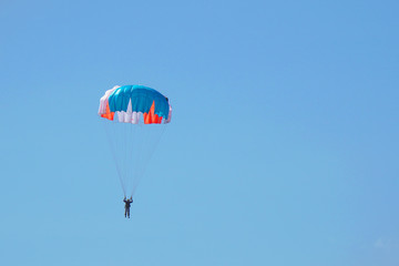Skydiver flying in blue in sky