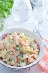 Salad with shrimps and fresh cucumber on a white background, selective focus