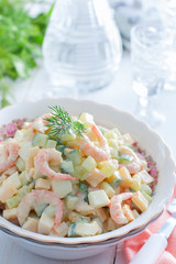 Salad with shrimps and fresh cucumber on a white background, selective focus