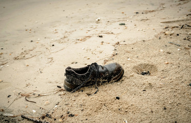 shoes garbage the beach / sea water pollution with old shoes save the earth