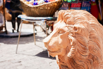 Statue of a lion made of red clay in the street of Taormina, Sicily, Italy