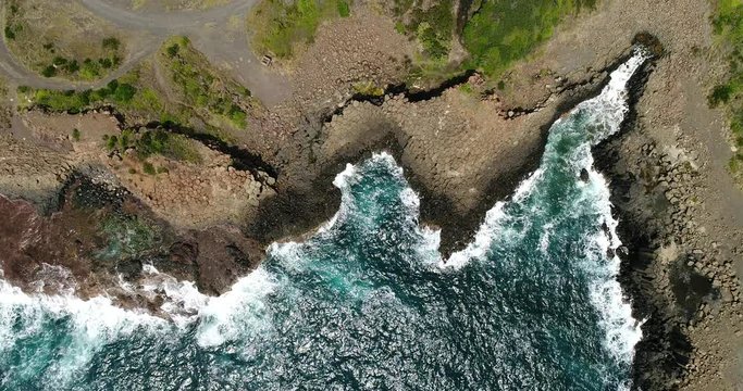 Bay of rolling waves eroding hexagonal basalt rocks of Bombo Quarry in Kiama town on Australian Pacific coast.
