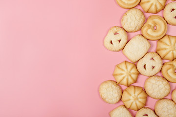 Danish butter cookies on pink background with space for your text.