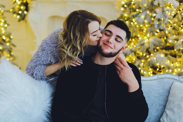 Couple in love: a guy and a girl on the background of the Christmas tree. Christmas background 